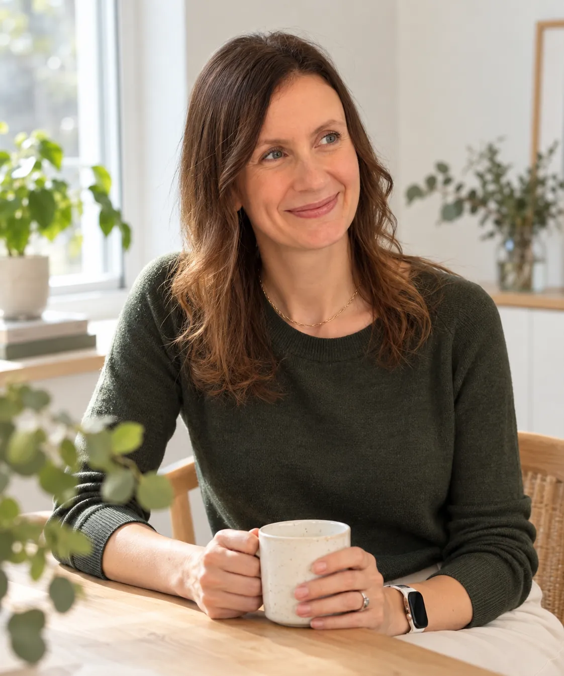 Martina Bartolomucci smiling at a table, holding a cup of coffee
